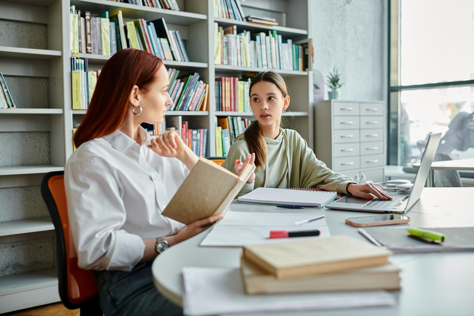 Engaging conversation between a young teacher and her student in a vibrant library setting